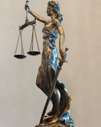 Description A detailed statue of Lady Justice holding scales and a sword, symbolizing law and fairness.