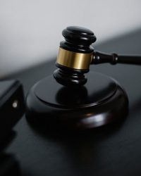 Description Close-up of a wooden gavel on a desk, symbolizing justice and legal authority.